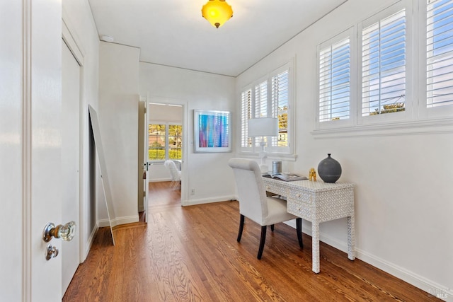 home office with wood finished floors and baseboards