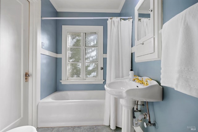 bathroom featuring a bathtub, crown molding, and tile patterned floors