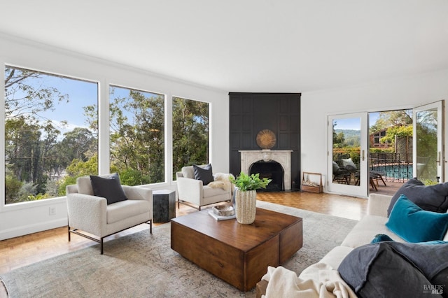 living room featuring a large fireplace and baseboards