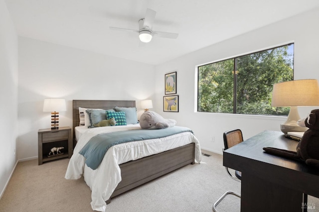 carpeted bedroom featuring visible vents, ceiling fan, and baseboards