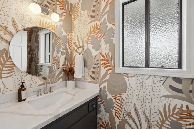 bathroom with vanity and wallpapered walls