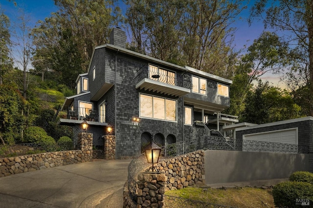 view of front of home with a garage and a chimney