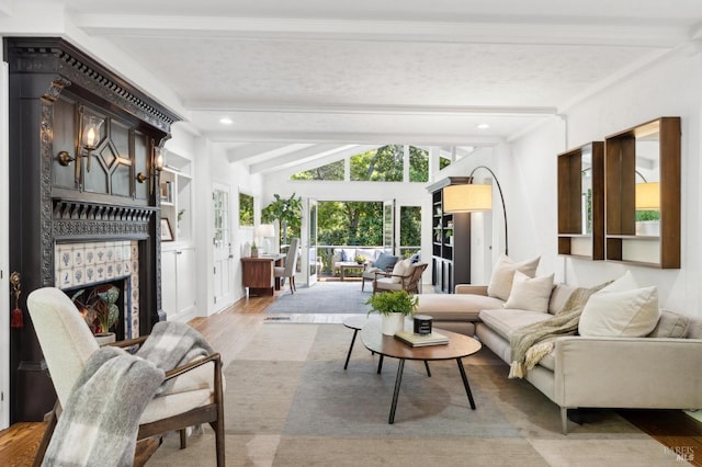 interior space with vaulted ceiling with beams and a fireplace