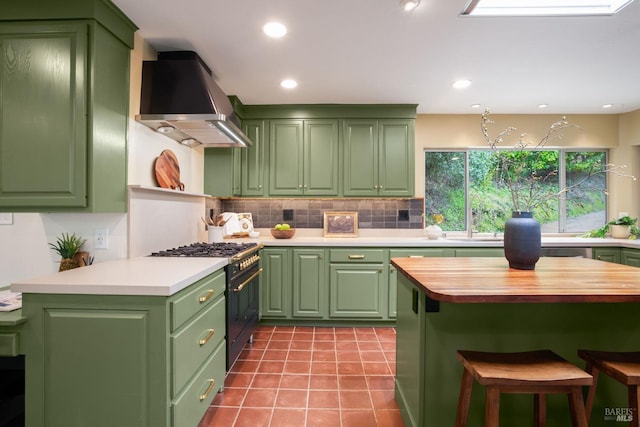 5 Madrone Ave, Woodacre, CA 94973 - kitchen with high end range, a kitchen bar, tile patterned floors, tasteful backsplash, and wall chimney exhaust hood