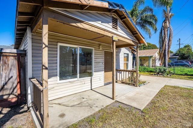 back of property with a patio area and fence