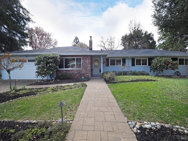 single story home with a garage, a chimney, and a front yard