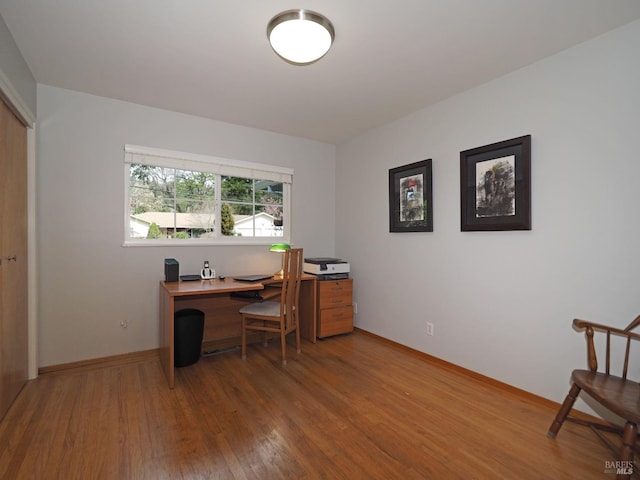 home office featuring baseboards and hardwood / wood-style floors