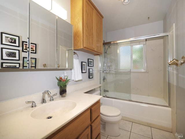 full bathroom with tile patterned floors, toilet, shower / bath combination with glass door, and vanity