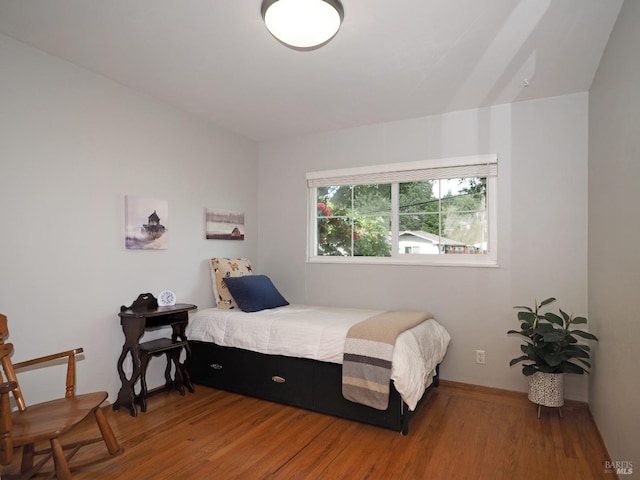 bedroom featuring wood finished floors