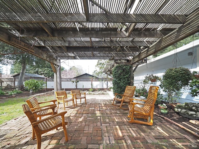 view of patio featuring a pergola and fence