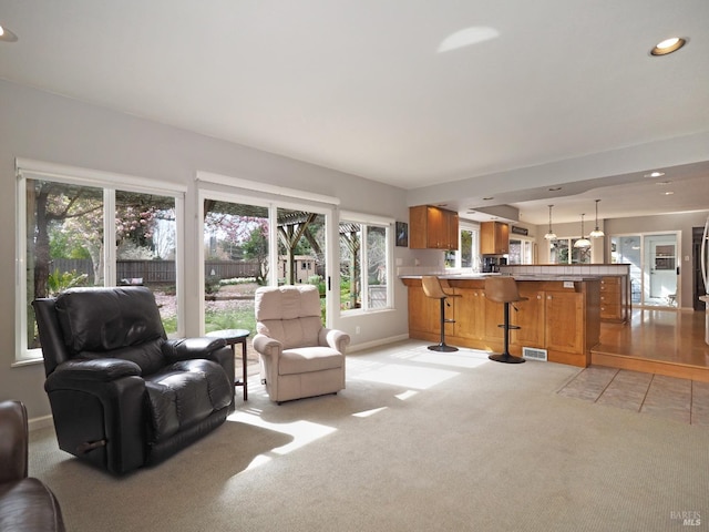 living room with light carpet, visible vents, recessed lighting, and baseboards