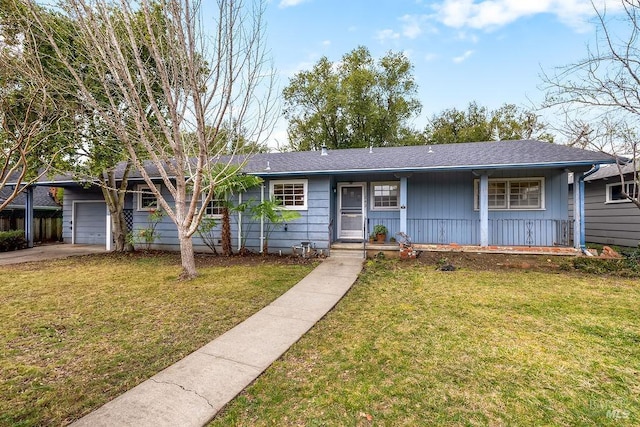 ranch-style house with a garage, a porch, board and batten siding, and a front yard