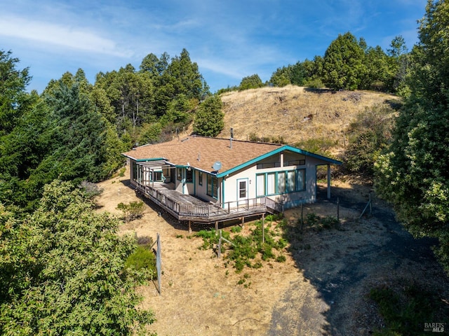 rear view of property with a wooden deck