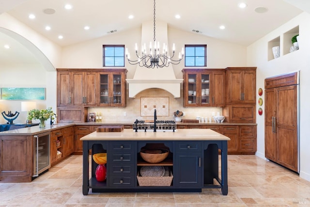 kitchen with visible vents, brown cabinetry, wine cooler, light countertops, and open shelves