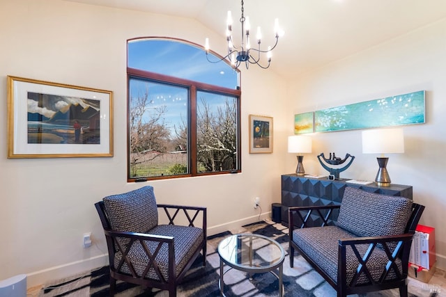 living area featuring lofted ceiling, a notable chandelier, and baseboards