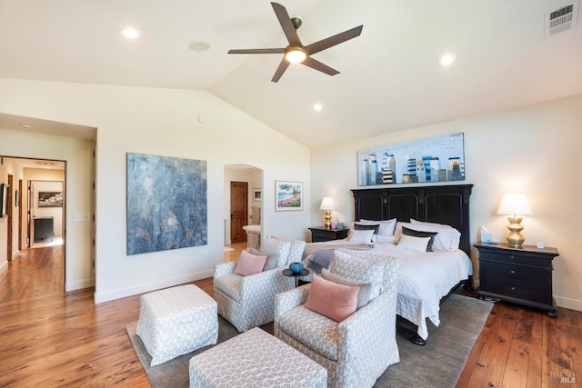 bedroom with arched walkways, lofted ceiling, visible vents, hardwood / wood-style floors, and baseboards