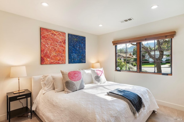 carpeted bedroom with recessed lighting, visible vents, and baseboards