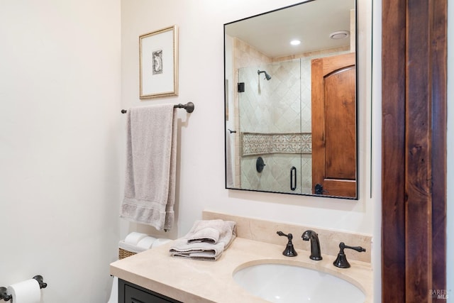 full bathroom featuring a stall shower and vanity