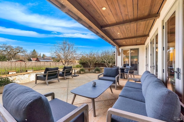 view of patio / terrace with french doors, outdoor lounge area, and fence