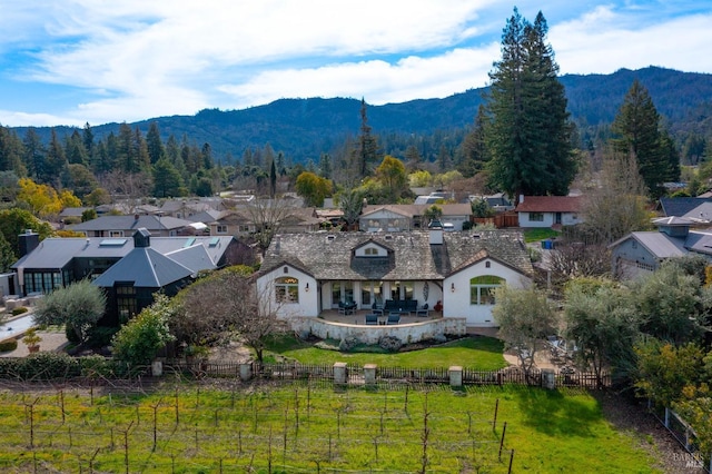 drone / aerial view with a residential view, a mountain view, and a wooded view