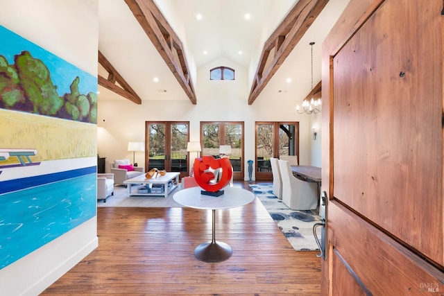 interior space featuring high vaulted ceiling, wood-type flooring, beam ceiling, and a notable chandelier