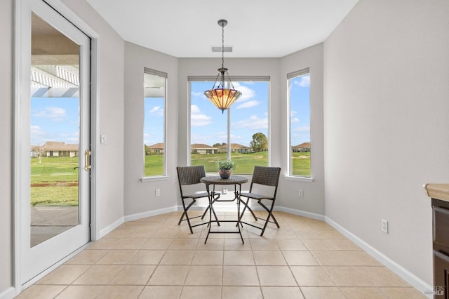 dining space with light tile patterned floors, plenty of natural light, and visible vents
