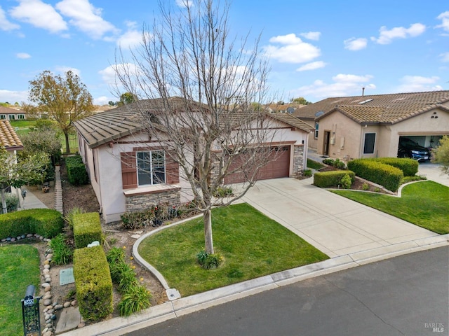 view of front of house featuring a garage, a tile roof, driveway, stucco siding, and a front lawn