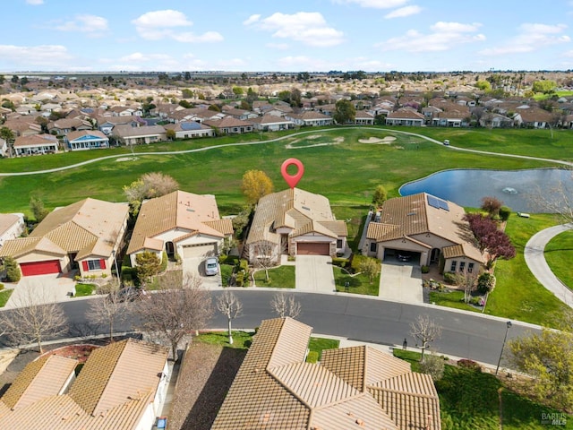 birds eye view of property with a water view and a residential view