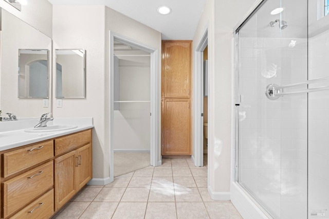 bathroom featuring a shower stall, vanity, and tile patterned floors