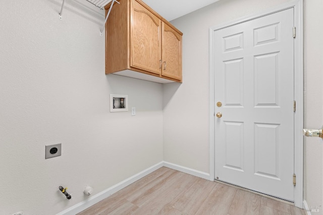 washroom with washer hookup, baseboards, light wood-style floors, cabinet space, and electric dryer hookup