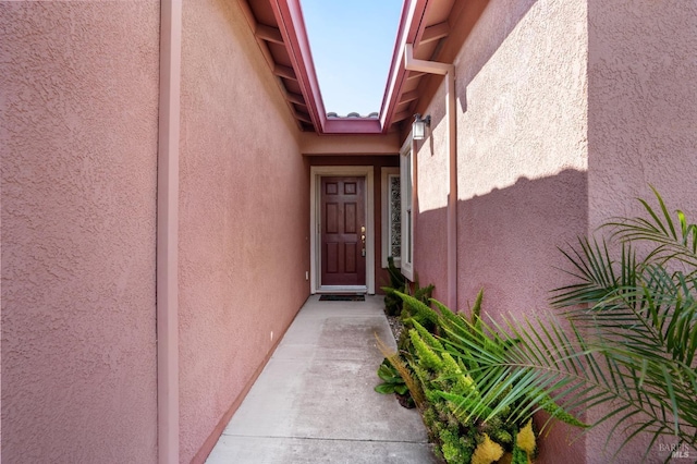 entrance to property featuring stucco siding