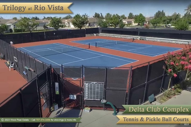 view of tennis court featuring fence