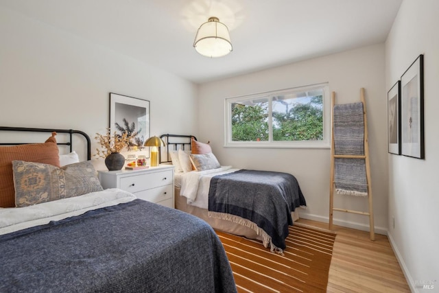 bedroom with baseboards and light wood-style floors