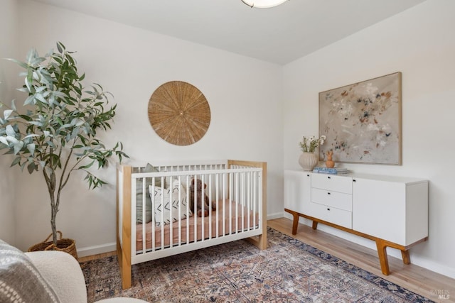 bedroom featuring baseboards and wood finished floors