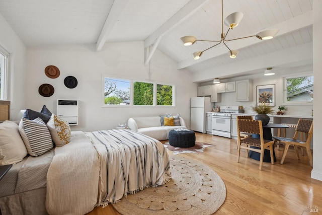 bedroom with freestanding refrigerator, heating unit, lofted ceiling with beams, and light wood finished floors