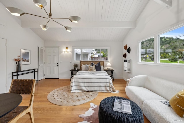 bedroom with vaulted ceiling with beams, heating unit, and wood finished floors