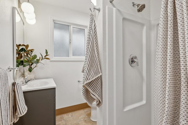 bathroom featuring baseboards, vanity, and a shower with shower curtain