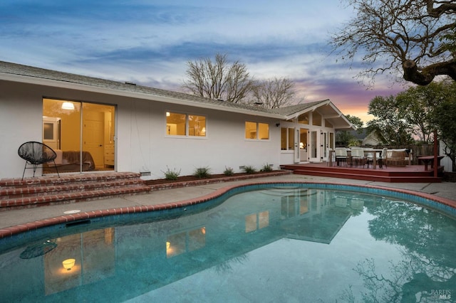 view of pool with a fenced in pool, outdoor dining space, french doors, and a deck