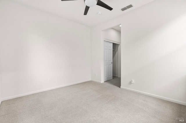 unfurnished bedroom featuring baseboards, visible vents, a ceiling fan, and light colored carpet