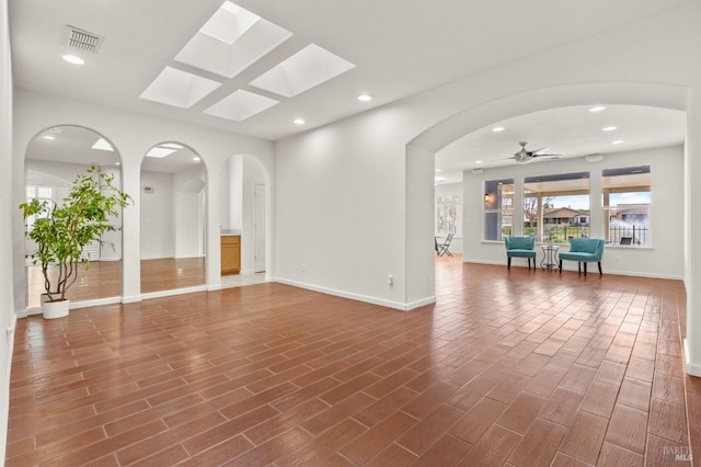 empty room featuring recessed lighting, wood finished floors, visible vents, baseboards, and a ceiling fan