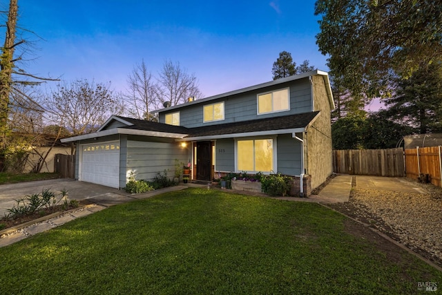 traditional-style house with roof with shingles, concrete driveway, an attached garage, a front yard, and fence