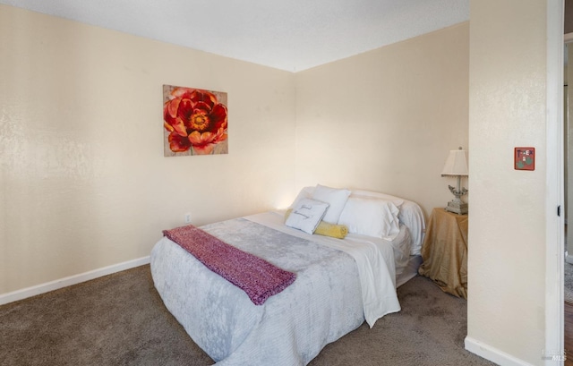 bedroom with carpet floors and baseboards