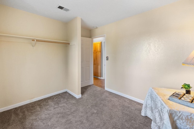 unfurnished bedroom featuring carpet floors, visible vents, and baseboards