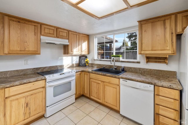 kitchen featuring white appliances, light tile patterned flooring, a sink, and under cabinet range hood