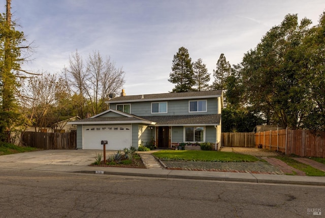 traditional-style home featuring fence, driveway, and an attached garage