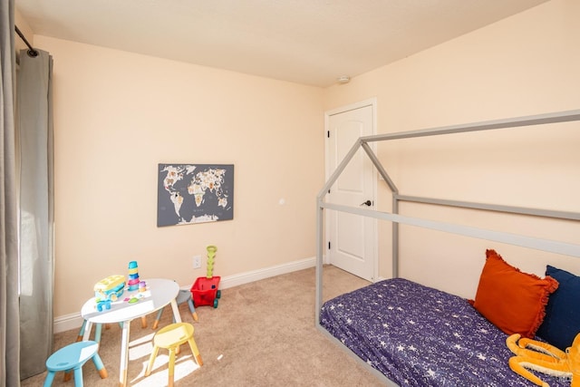 carpeted bedroom with baseboards