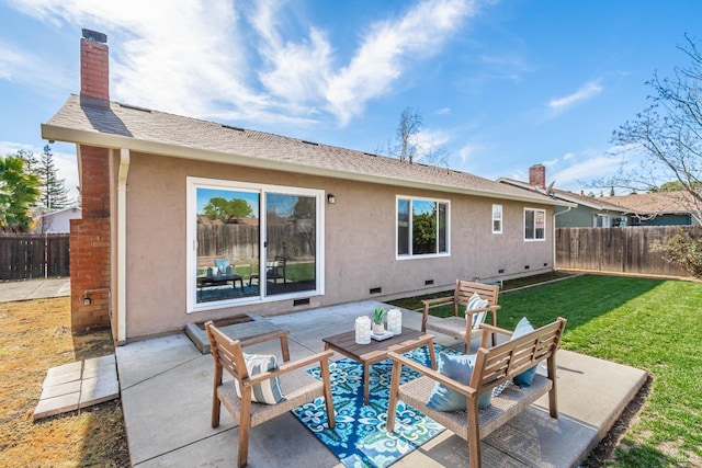 rear view of property with a lawn, a patio, a chimney, crawl space, and stucco siding