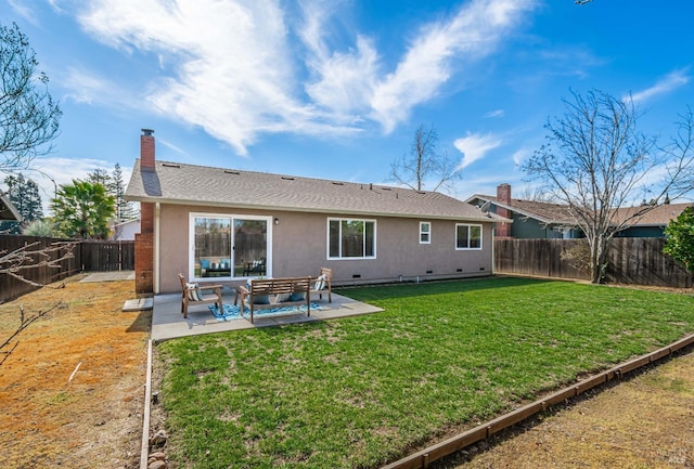 back of property with a fenced backyard, crawl space, a yard, a patio area, and stucco siding