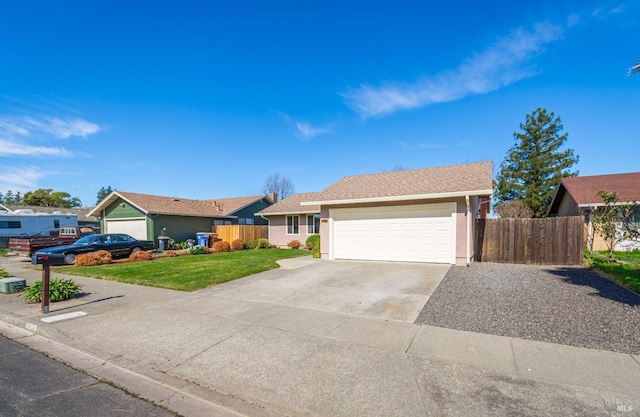 ranch-style house featuring a garage, concrete driveway, a front yard, and fence