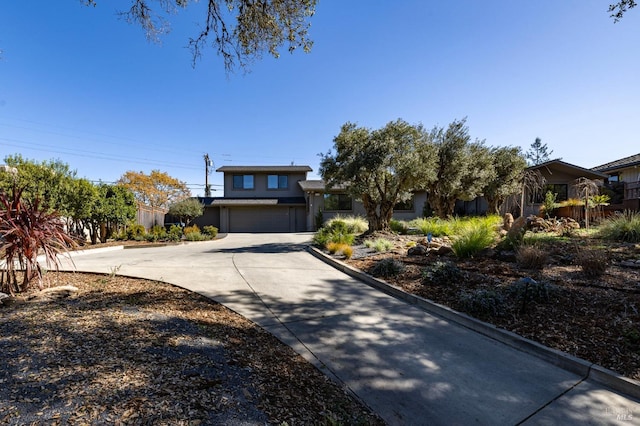 view of front of home featuring driveway, an attached garage, and stucco siding